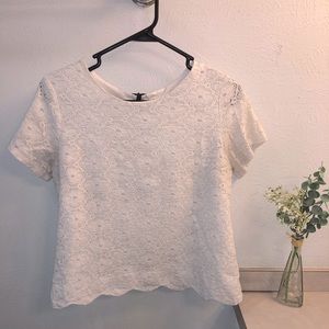 Monteau White floral top with black zipper on the back